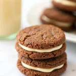 Ginger Molasses Sandwich Cookies with Eggnog Frosting