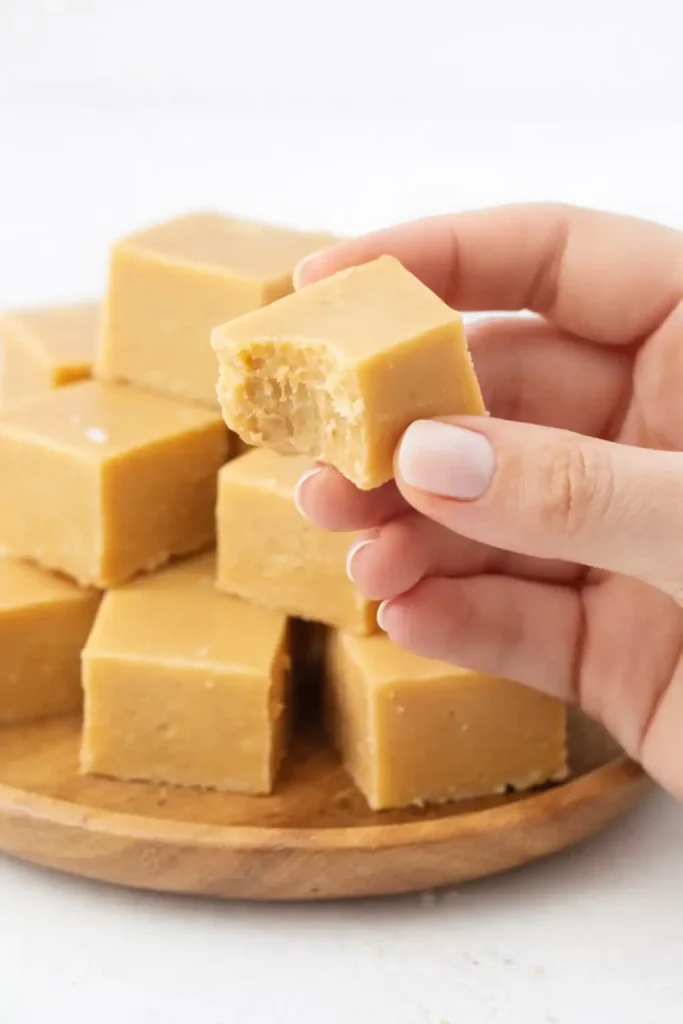 Smooth and creamy pumpkin pie fudge cut into neat squares, topped with a light sprinkle of cinnamon