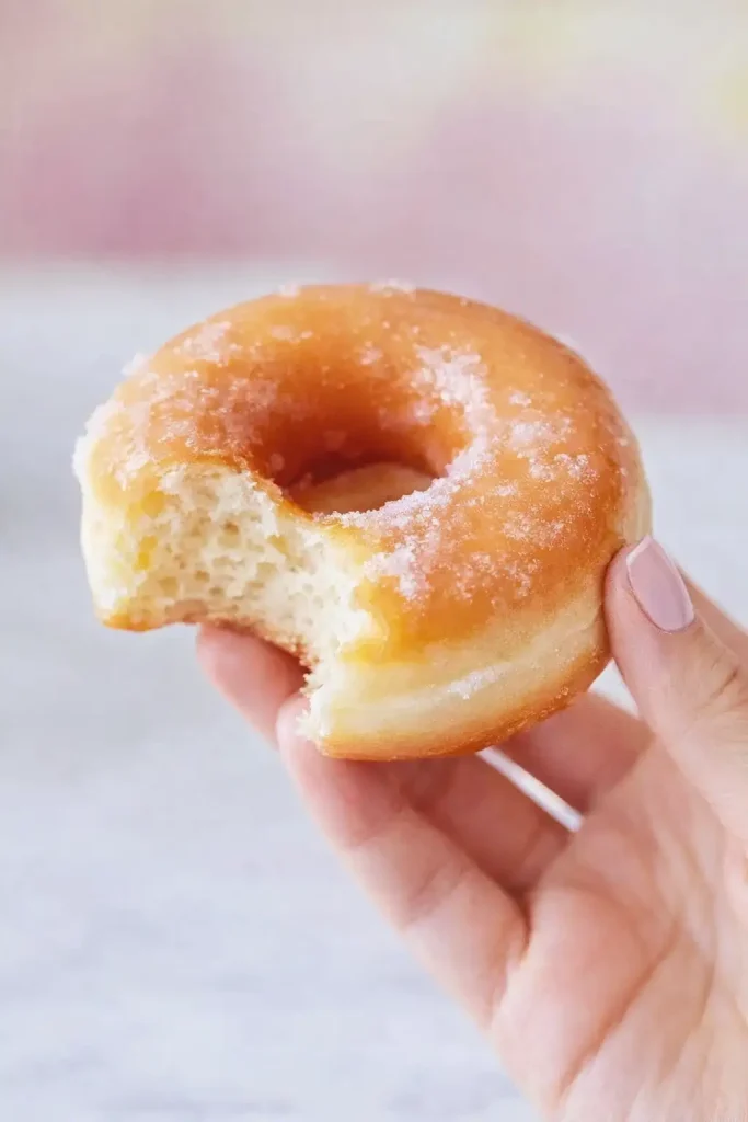 Gluten-free donut dough shaped into rings and arranged on a tray, ready to be cooked in the air fryer